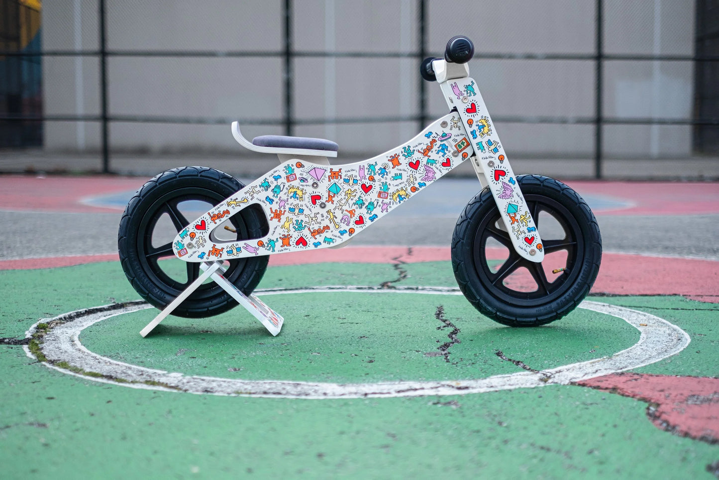 Keith Haring kids balance bike side view with colorful graphics