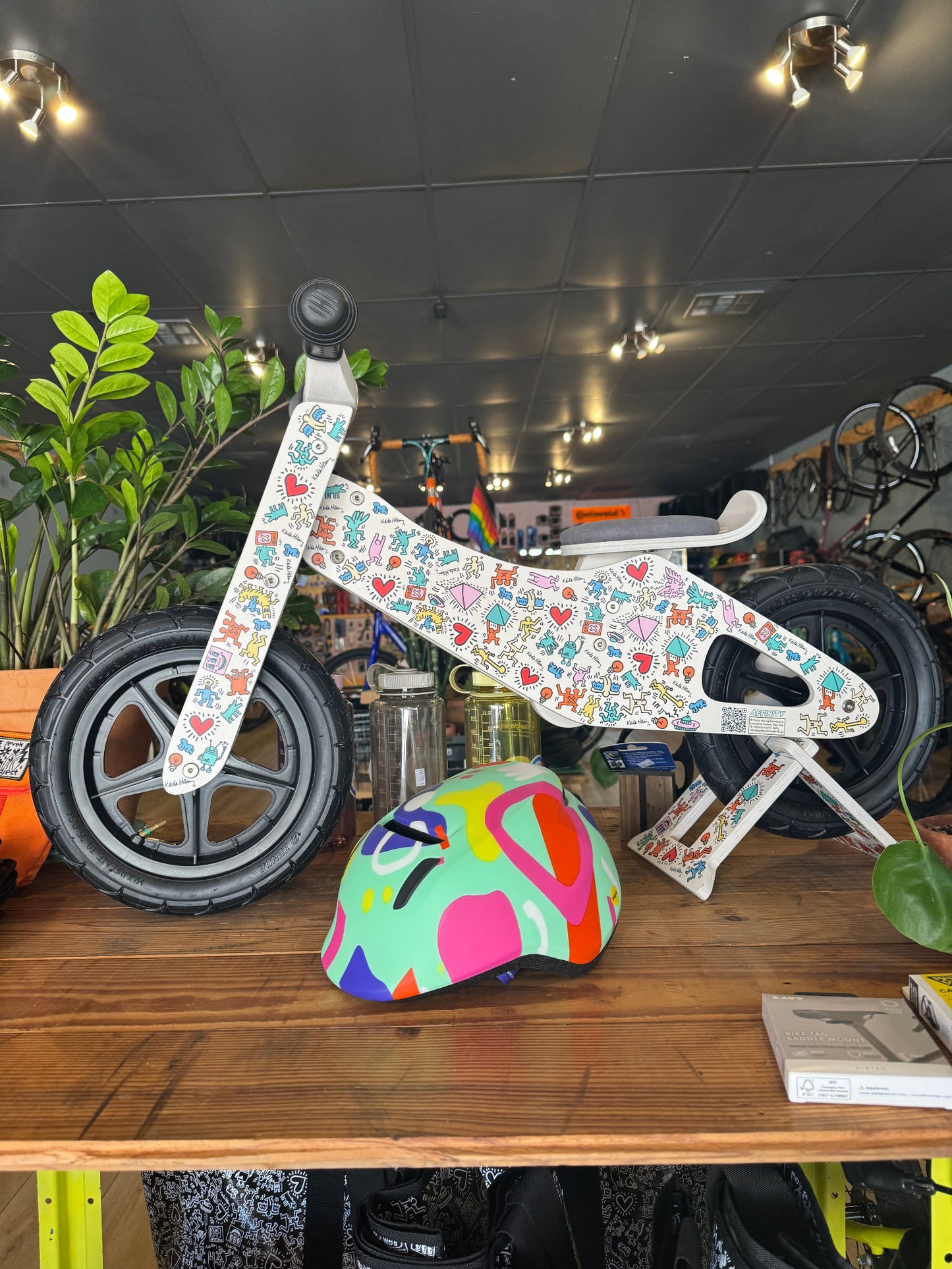 Keith Haring limited edition push bike and colorful helmet displayed in bike shop