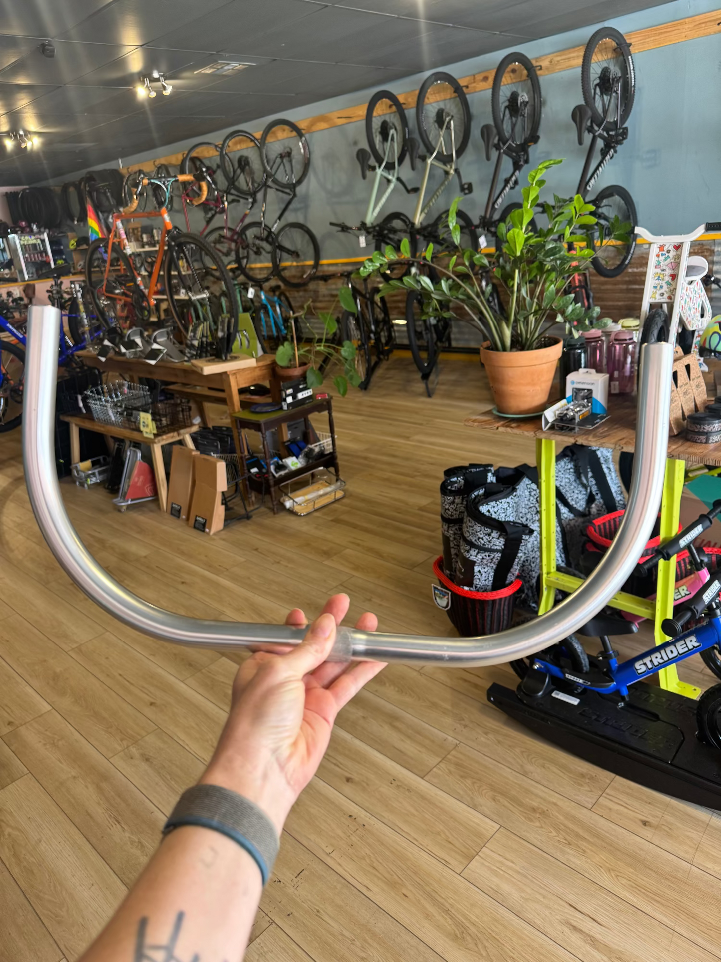 Holding Nitto B617 Promenade handlebar in shop, showing sweep and clamp area detail.