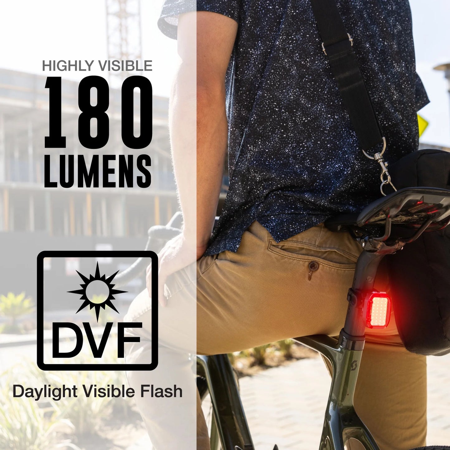 Person riding a bicycle with an illuminated  Nite rider VMAX +180 bike taillight, highlighting '180 Lumens' and 'DVF' (Daylight Visible flash)
