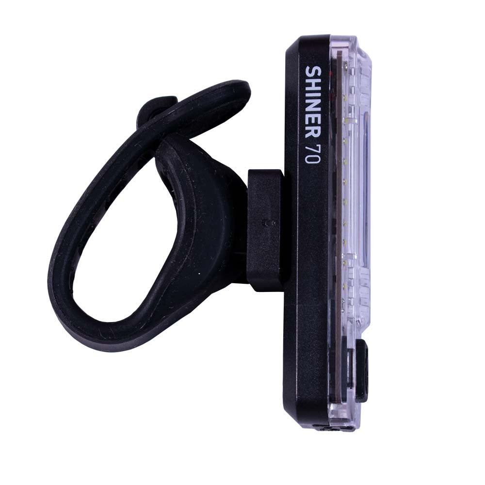 Planet Bike bicycle light with 'SHINER 70' branding on a white background, showing rubber mounting bracket.